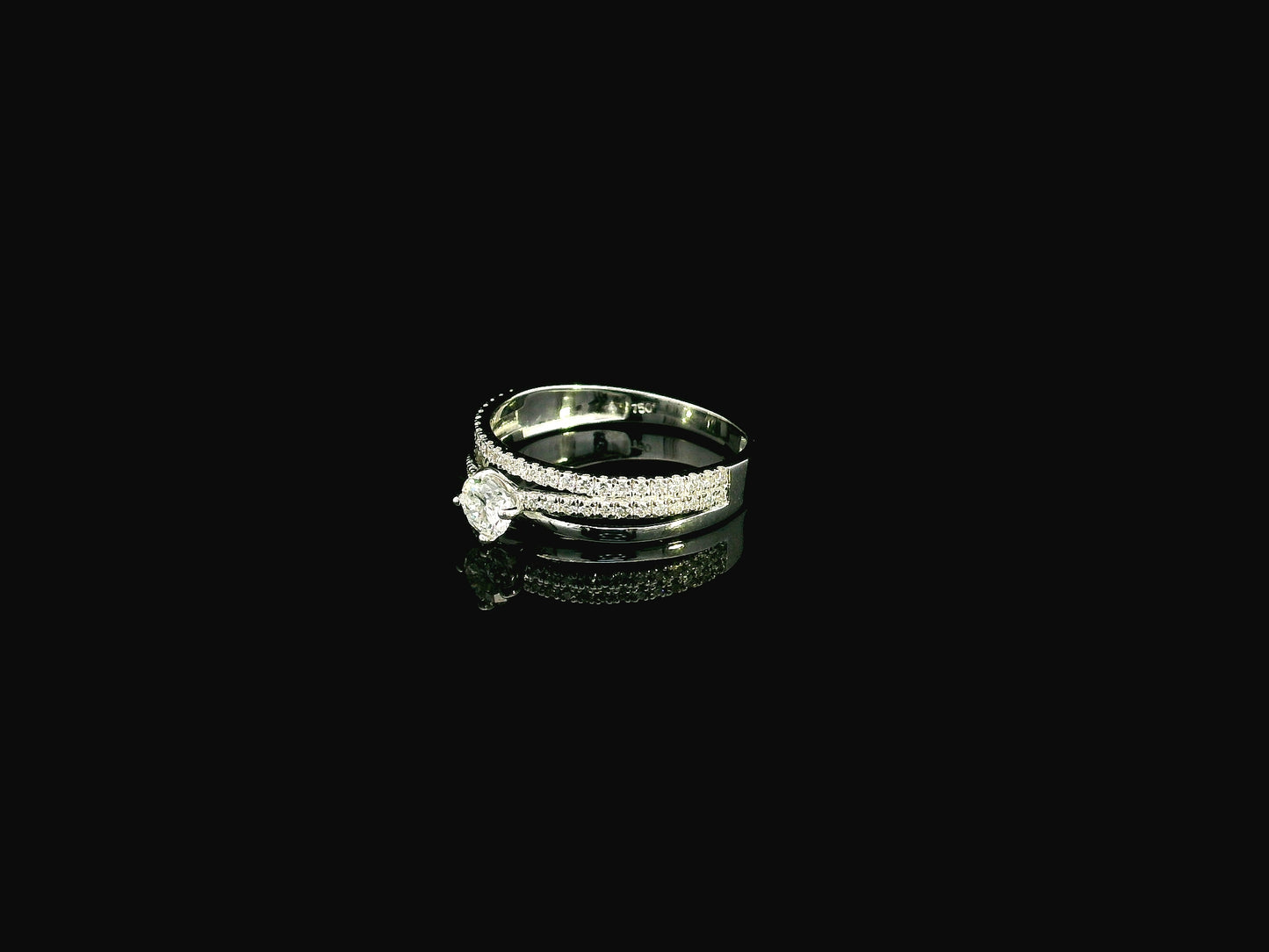18K white gold diamond engagement ring featuring a 0.30 carat round center diamond and triple-row band with 0.28 carats of accent diamonds.