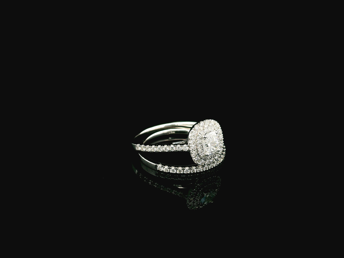 GIA certified cushion cut diamond bridal ring set in 18K white gold with halo engagement ring and matching diamond wedding band.