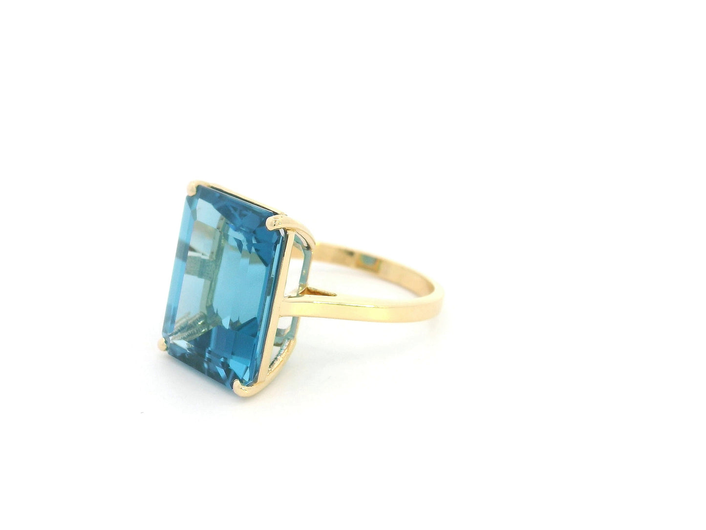 14.60 carat emerald cut London Blue Topaz solitaire ring in 18K yellow gold