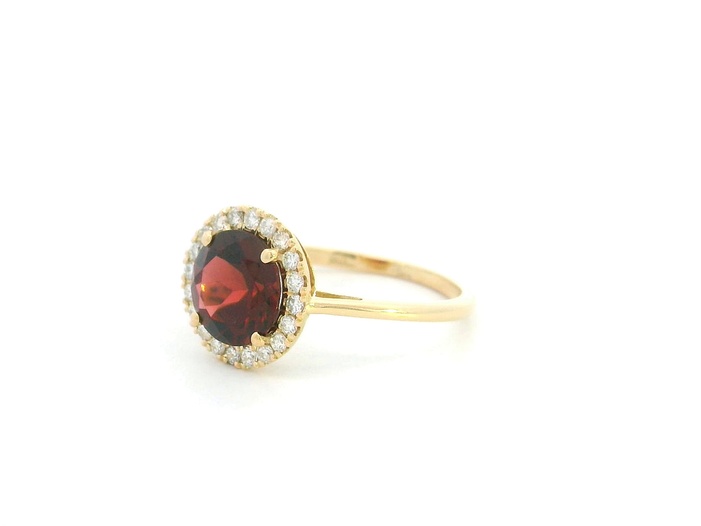 Garnet halo ring in 18K yellow gold featuring a 2.24 carat round garnet surrounded by natural diamonds