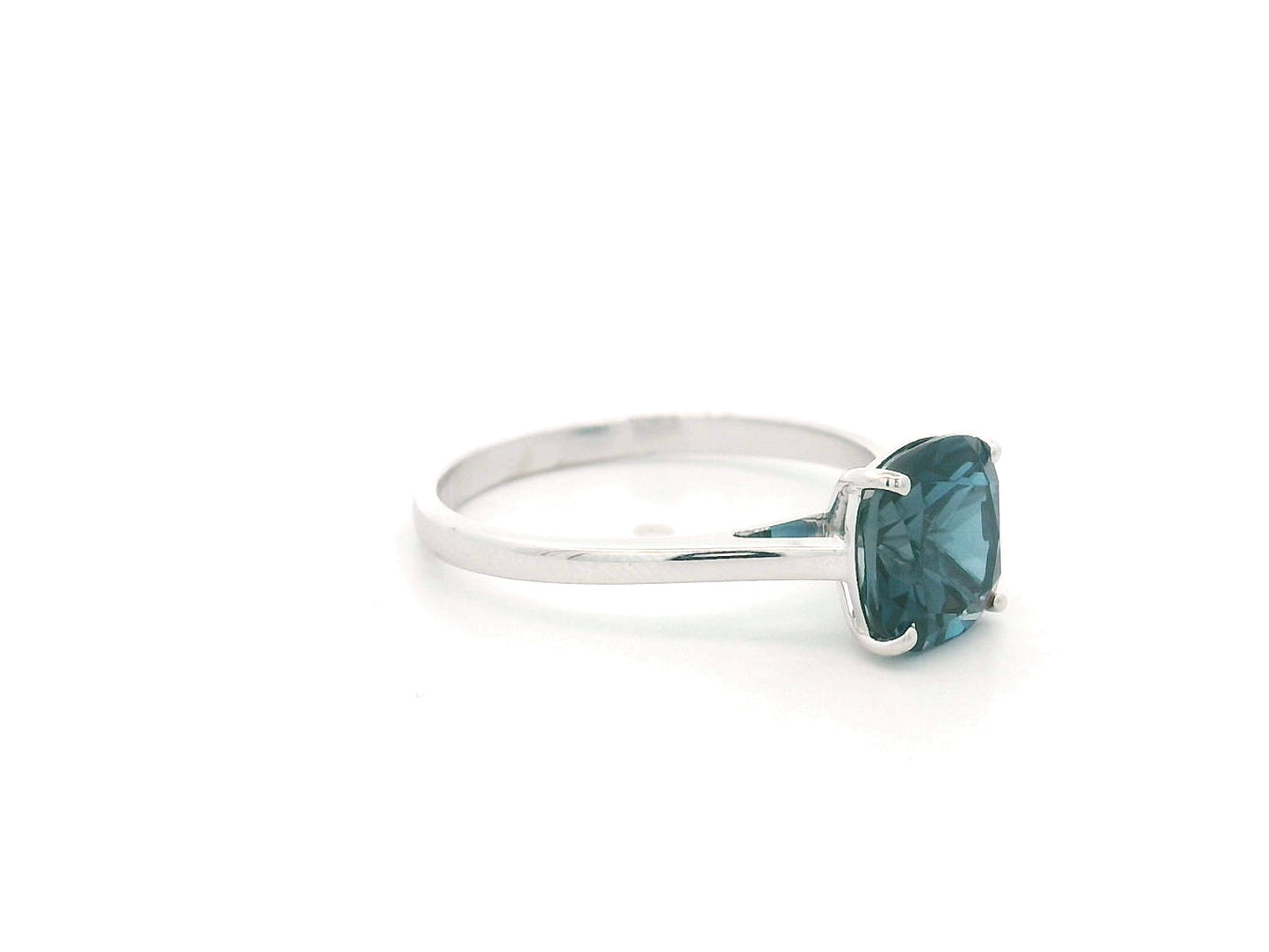 2.42 carat cushion cut London Blue Topaz solitaire ring in 18K white gold.