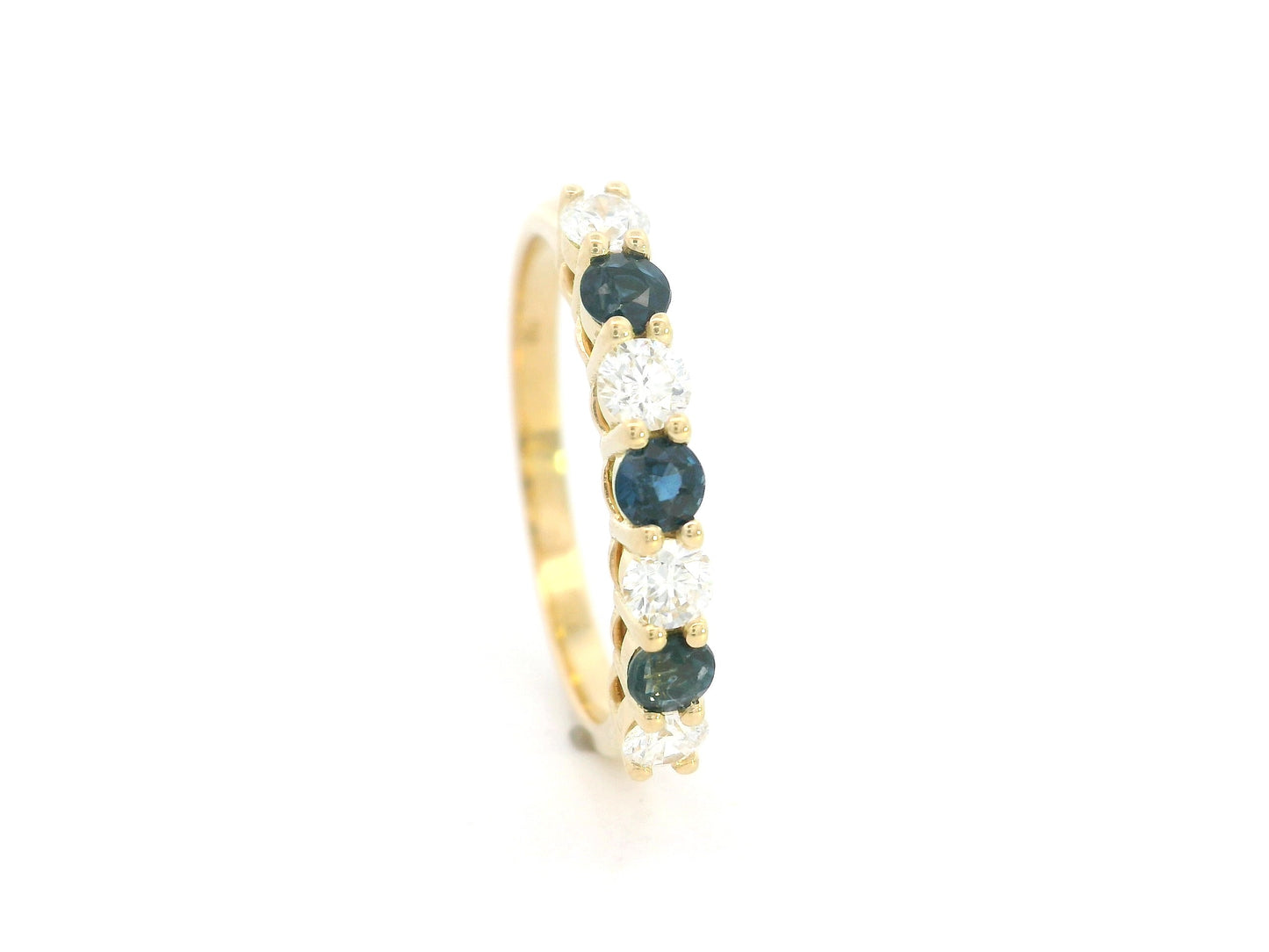 18K yellow gold half eternity ring featuring alternating natural blue sapphires and natural diamonds in a classic prong setting.