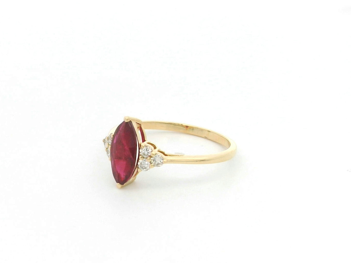 Natural 1.03 carat marquise ruby and diamond ring in solid 18K yellow gold with 0.21 carat natural diamond accents by Emirates Diamonds.