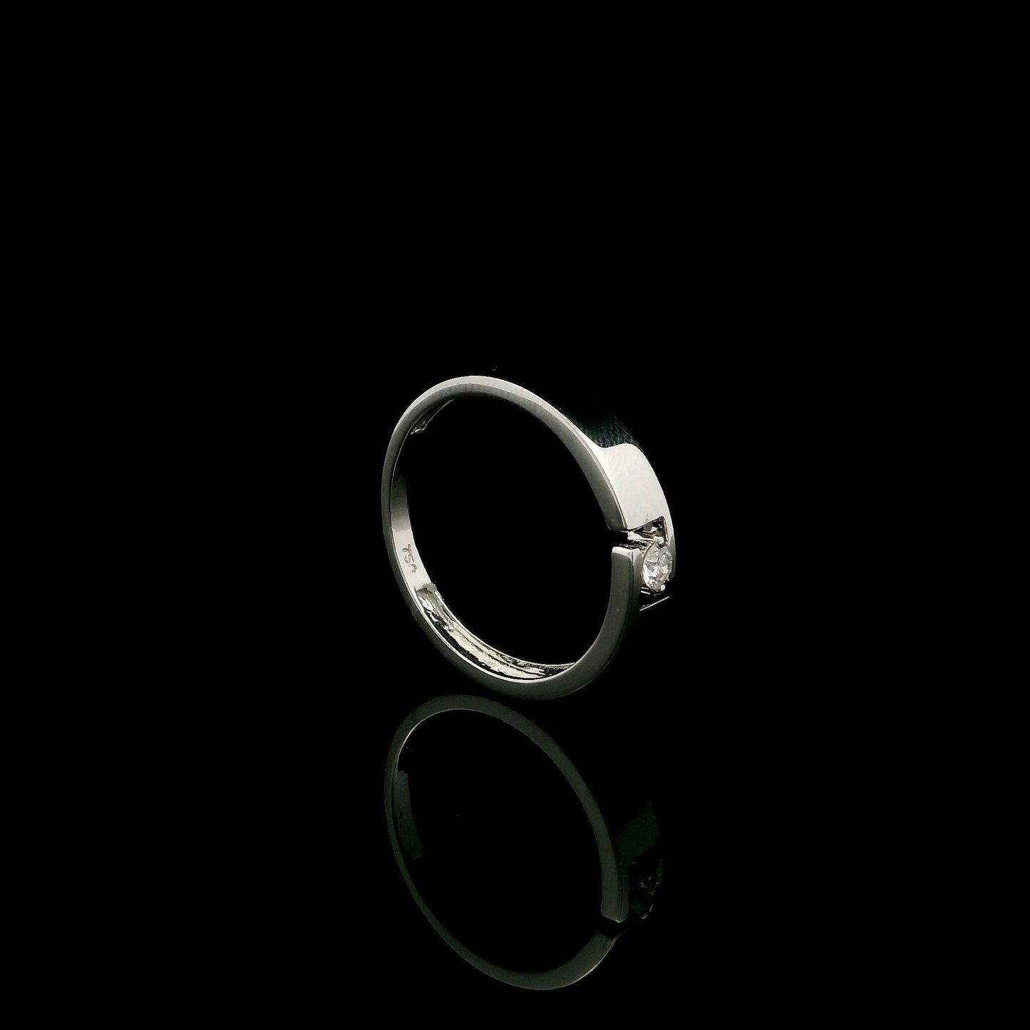 18K white gold floating diamond ring featuring a 0.08 carat natural round brilliant solitaire in a modern open band.