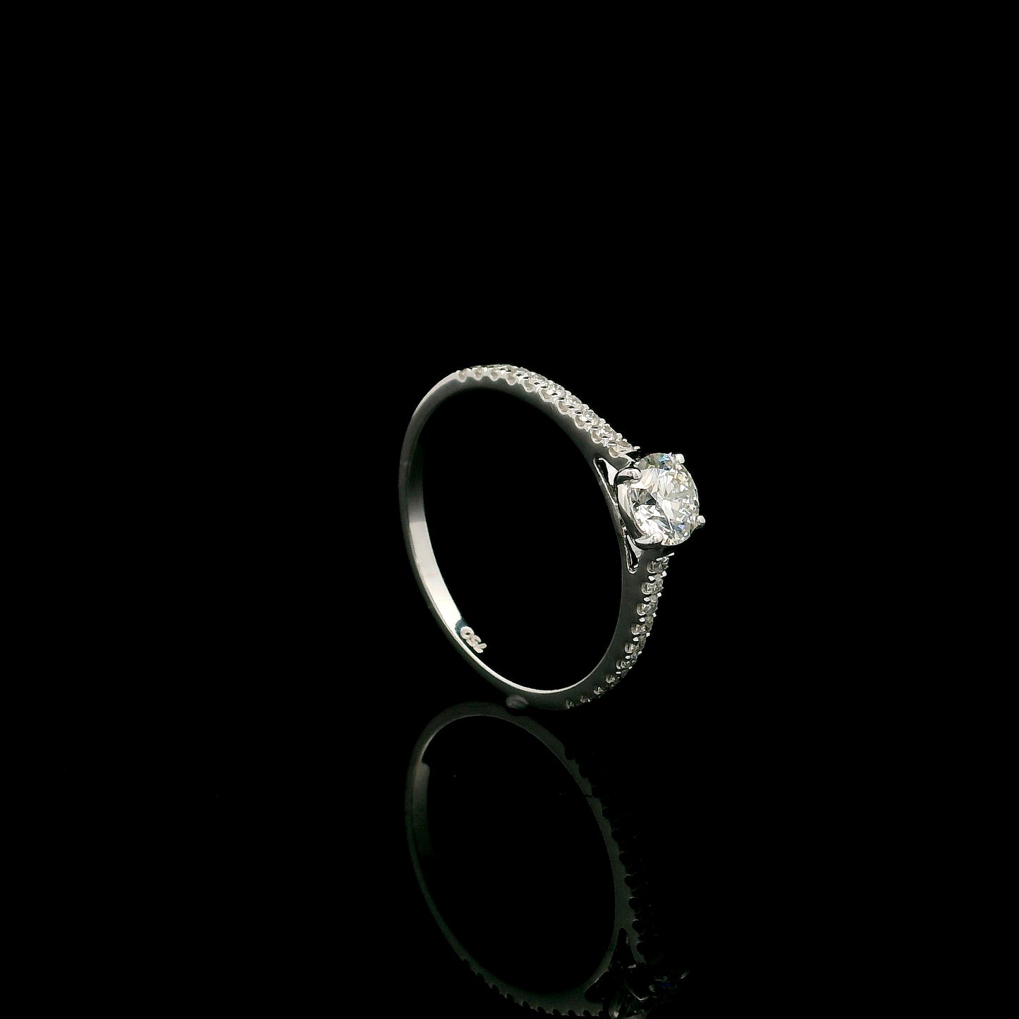 18K white gold round brilliant diamond solitaire engagement ring featuring a 0.51 carat GIA certified natural diamond with a pavé diamond band.