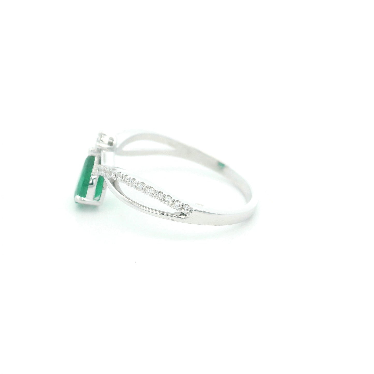 Pear shaped natural emerald and diamond ring in 18K white gold with diamond accented sculpted shoulders