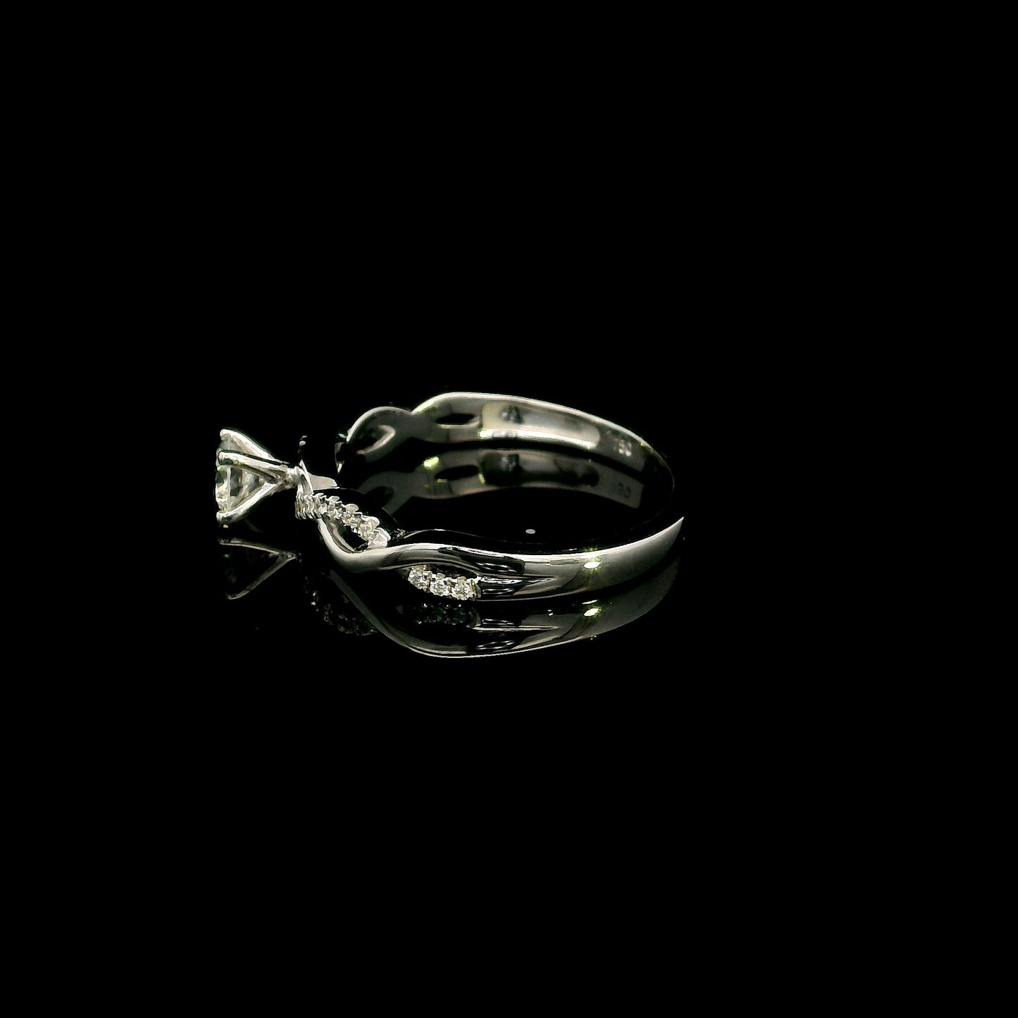 18K White Gold Diamond Engagement Ring with a 0.31 Carat Round Brilliant Diamond and 0.11 Carat Pavé Diamond Twisted Band.