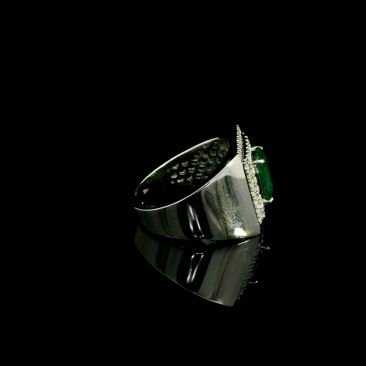 Men’s emerald and diamond statement ring in 18K white gold with rectangular green emerald and diamond surround.