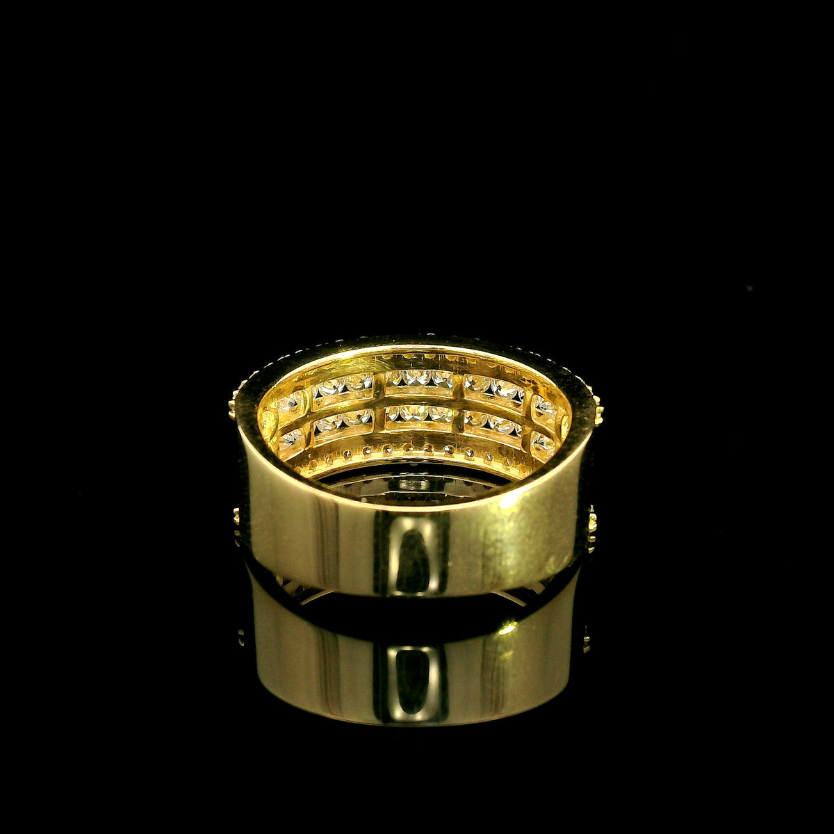 Wide diamond band ring in 18K yellow gold featuring four rows of round diamonds separated by polished gold bands.