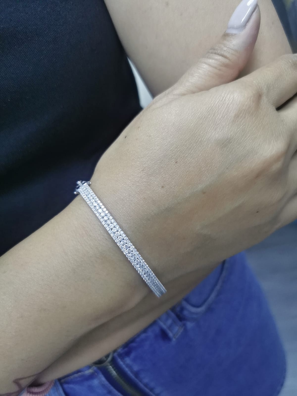 18K white gold bangle with triple row diamond setting featuring 2.36 carats of round diamonds and a secure clasp
