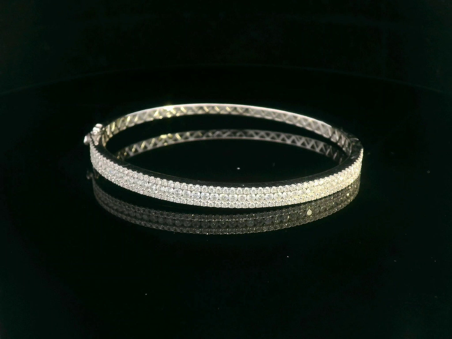 18K white gold bangle with triple row diamond setting featuring 2.36 carats of round diamonds and a secure clasp