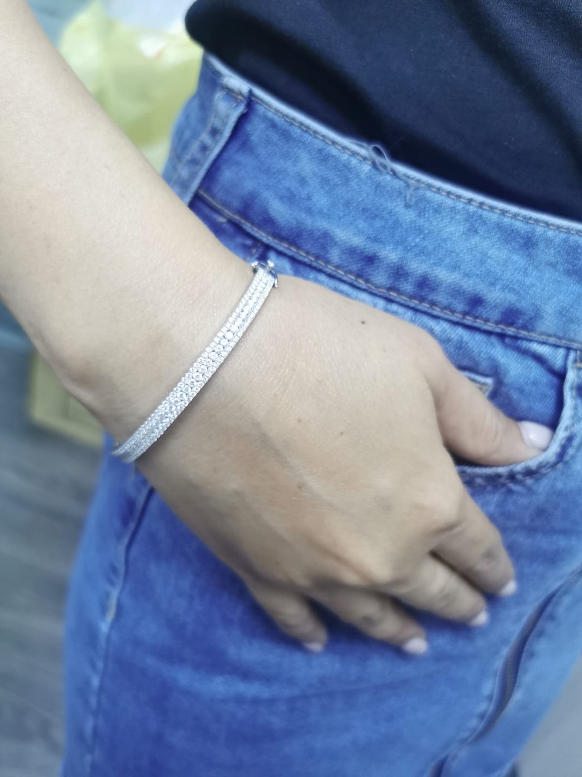 18K white gold bangle with triple row diamond setting featuring 2.36 carats of round diamonds and a secure clasp