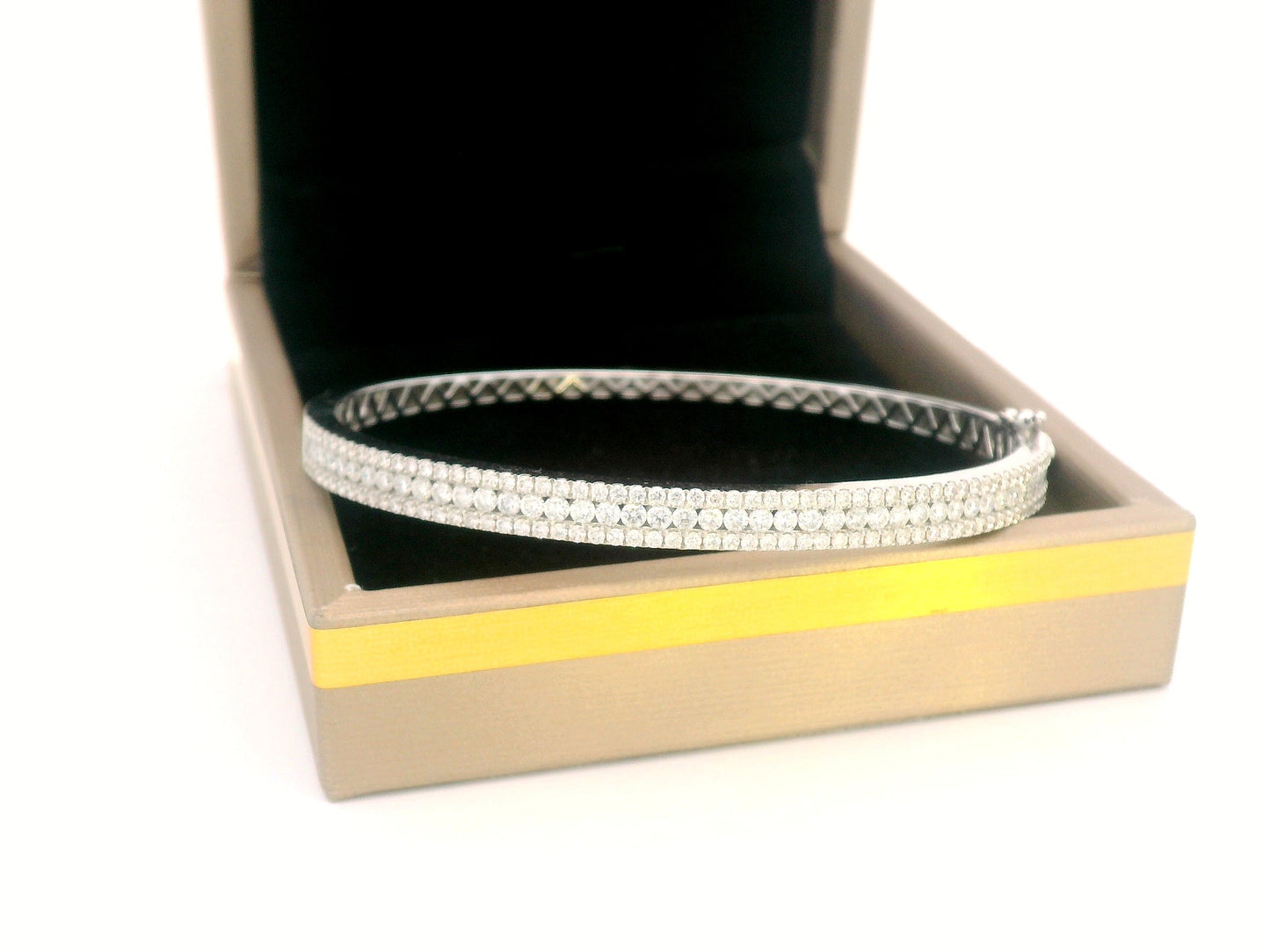 18K white gold bangle with triple row diamond setting featuring 2.36 carats of round diamonds and a secure clasp