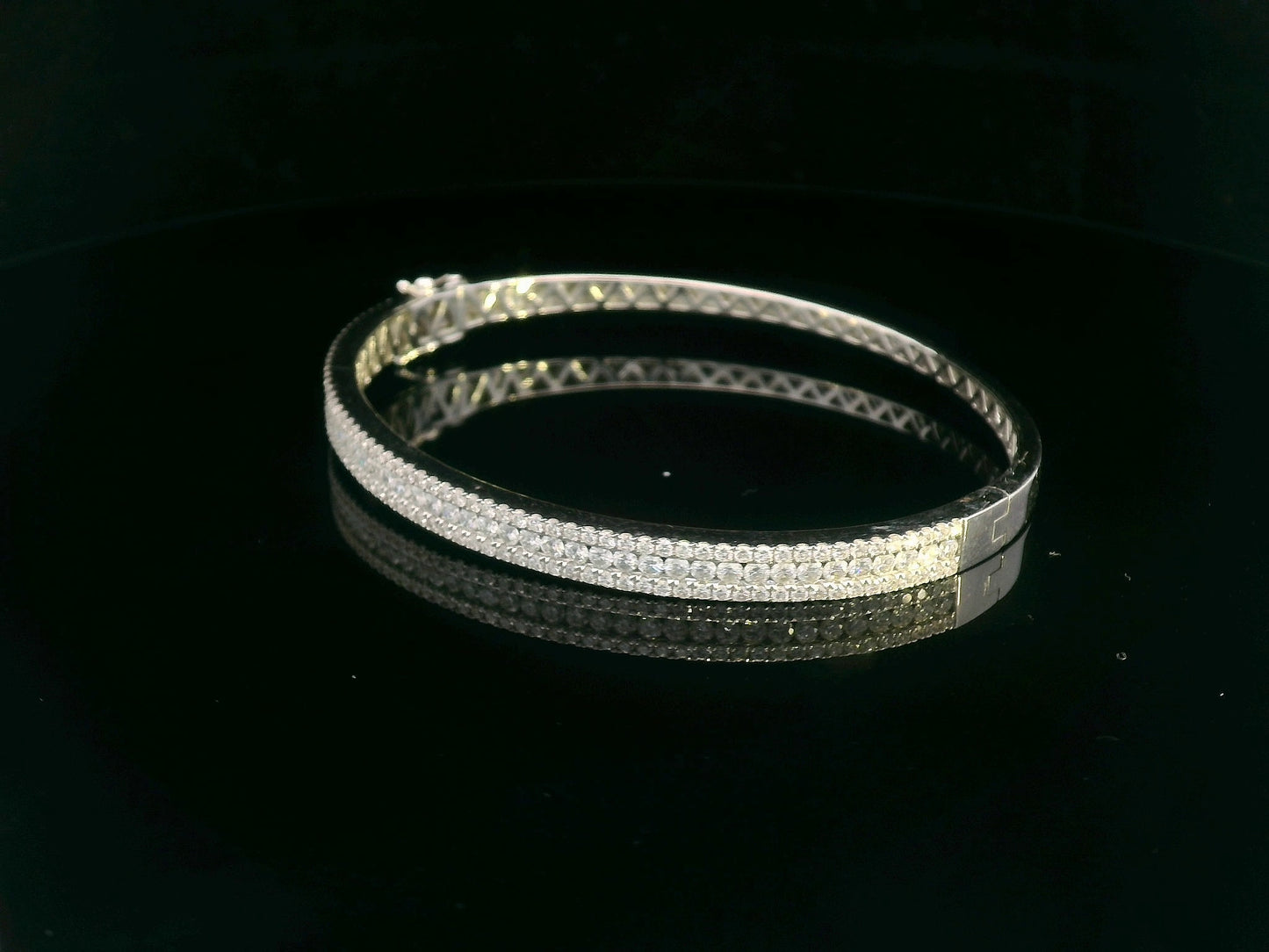 18K white gold bangle with triple row diamond setting featuring 2.36 carats of round diamonds and a secure clasp