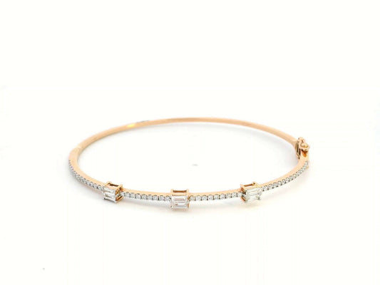 18K gold diamond bangle featuring round-cut and baguette-cut diamonds totaling 0.69 carats