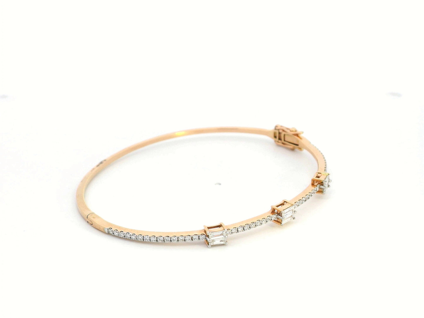 18K gold diamond bangle featuring round-cut and baguette-cut diamonds totaling 0.69 carats