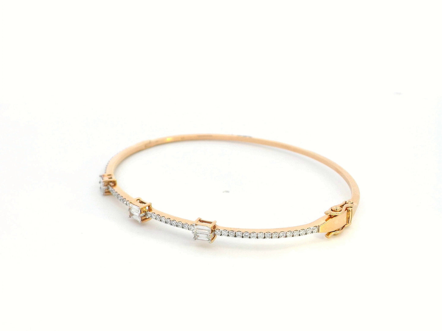 18K gold diamond bangle featuring round-cut and baguette-cut diamonds totaling 0.69 carats
