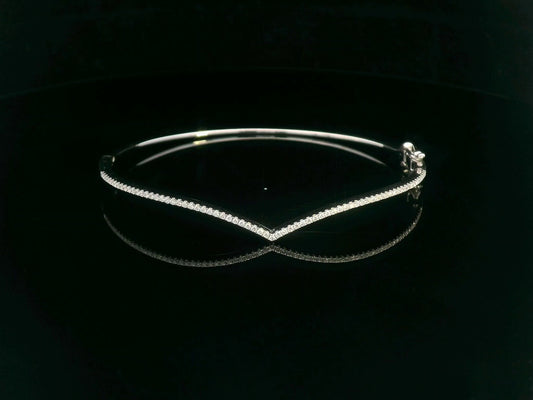 18K gold V-shape bangle bracelet with 0.34 carats of round-cut diamonds, featuring a modern tapered silhouette and minimalist design.