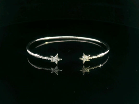 18K gold open bangle with pavé diamond star motifs on each end – 0.22 carats total.