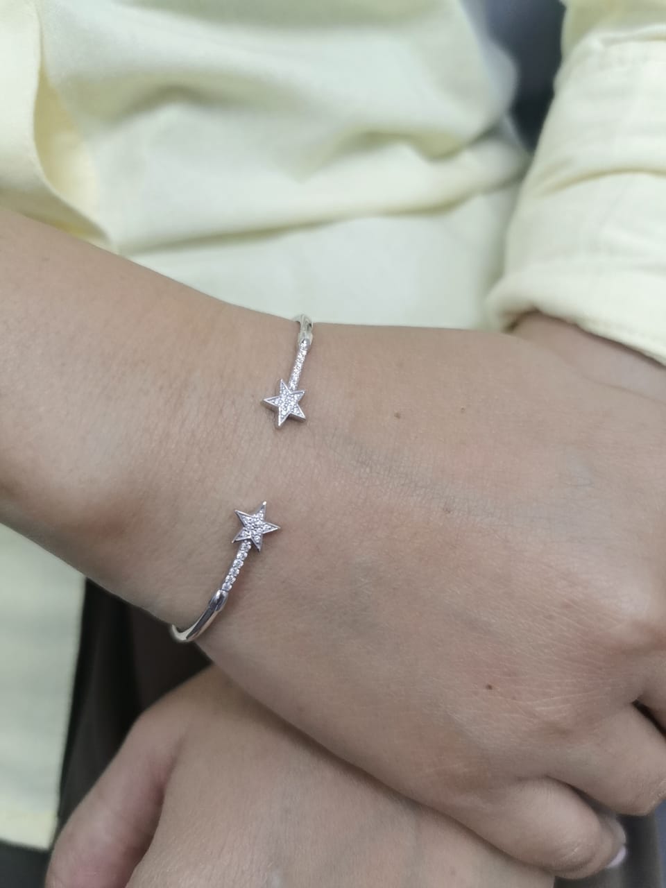 18K gold open bangle with pavé diamond star motifs on each end – 0.22 carats total.