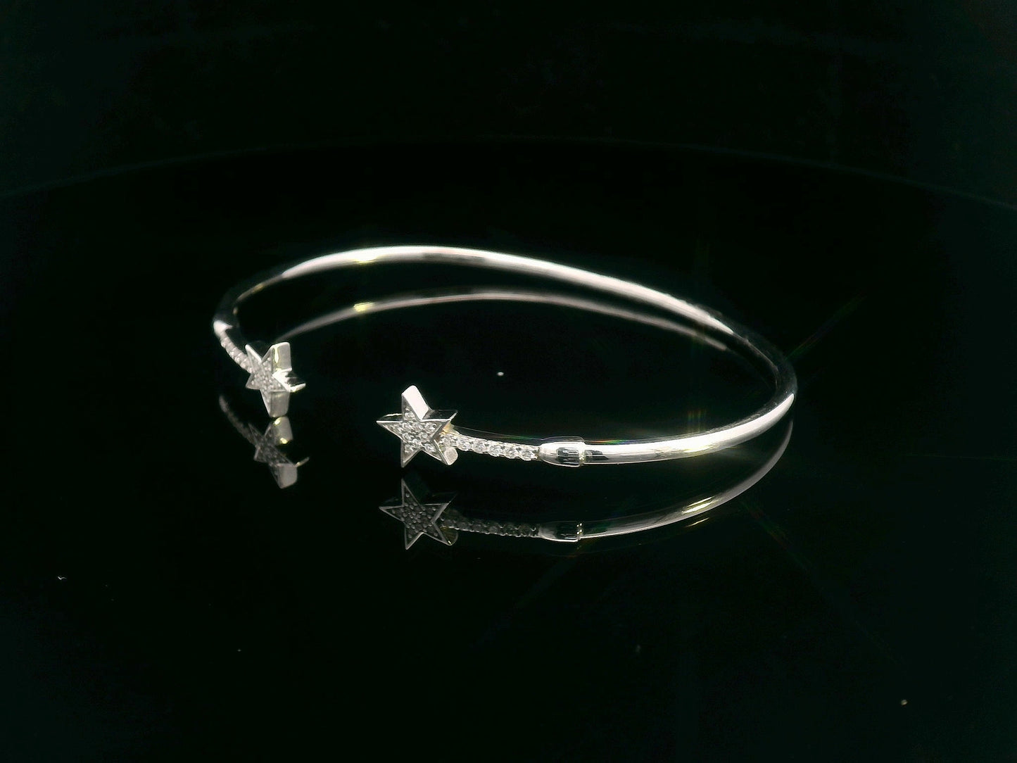 18K gold open bangle with pavé diamond star motifs on each end – 0.22 carats total.