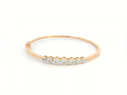 18K gold diamond bangle bracelet featuring 0.95 carats of round-cut diamonds in a clustered design, blending elegance with modern minimalism.