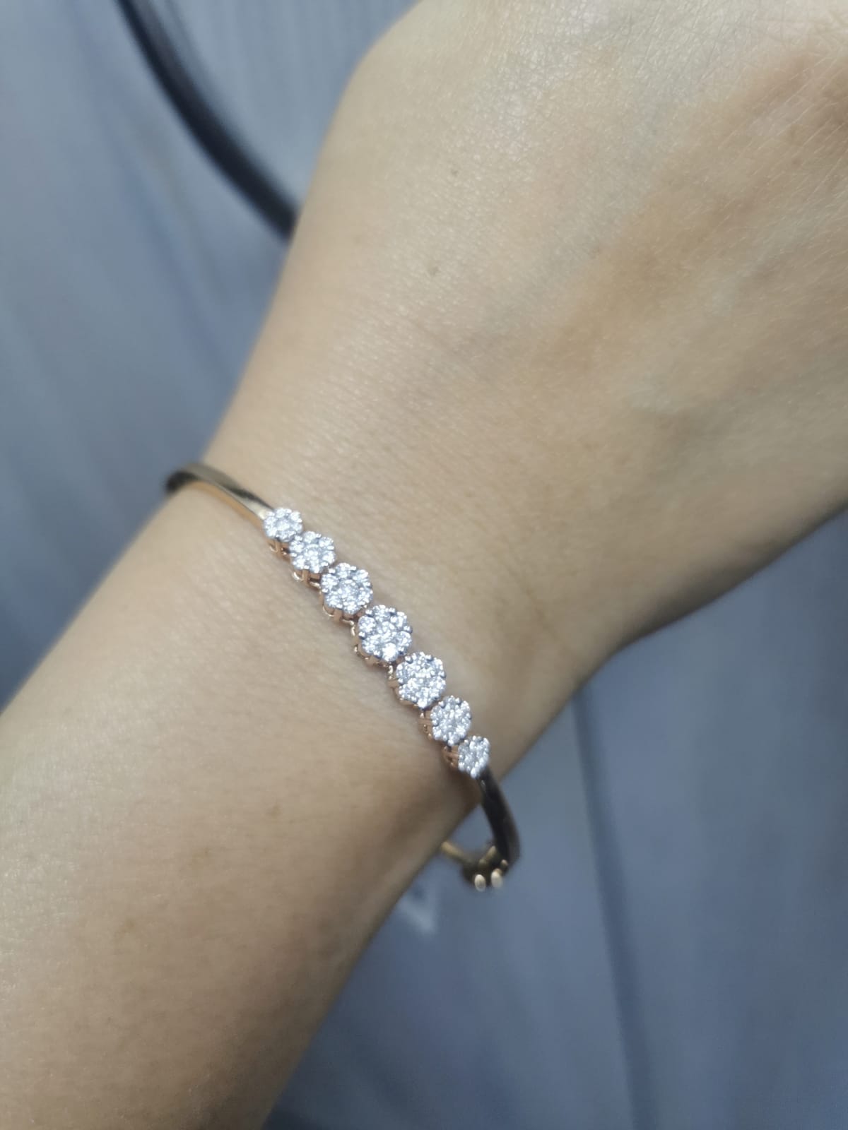 18K gold diamond bangle bracelet featuring 0.95 carats of round-cut diamonds in a clustered design, blending elegance with modern minimalism.