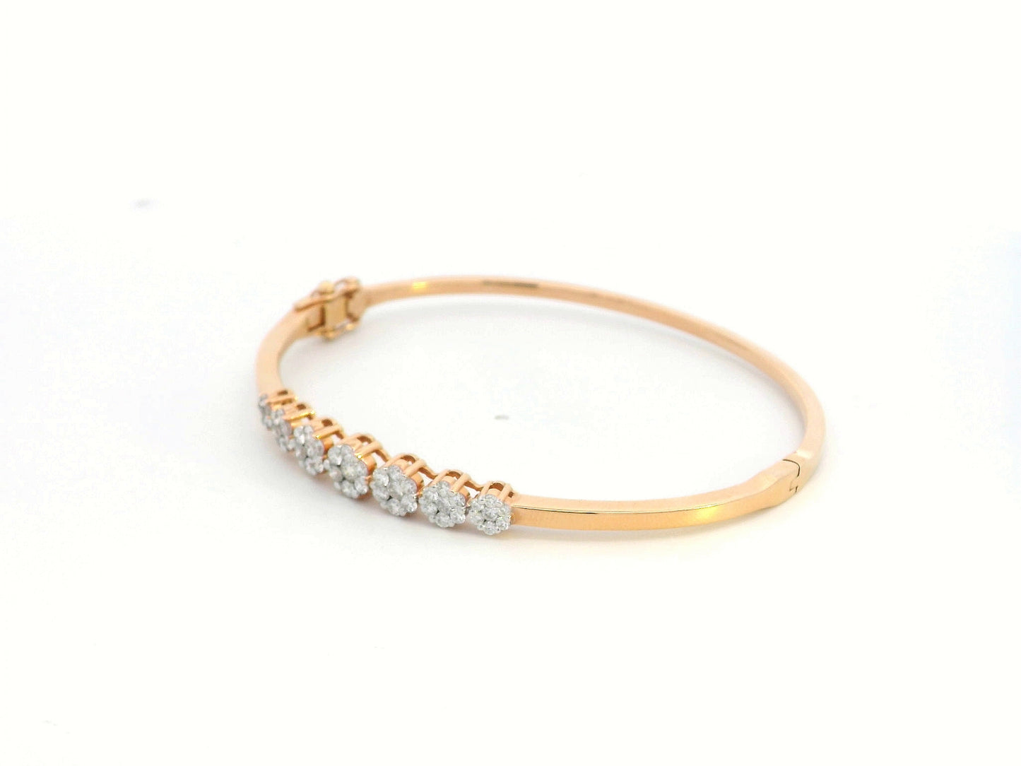 18K gold diamond bangle bracelet featuring 0.95 carats of round-cut diamonds in a clustered design, blending elegance with modern minimalism.