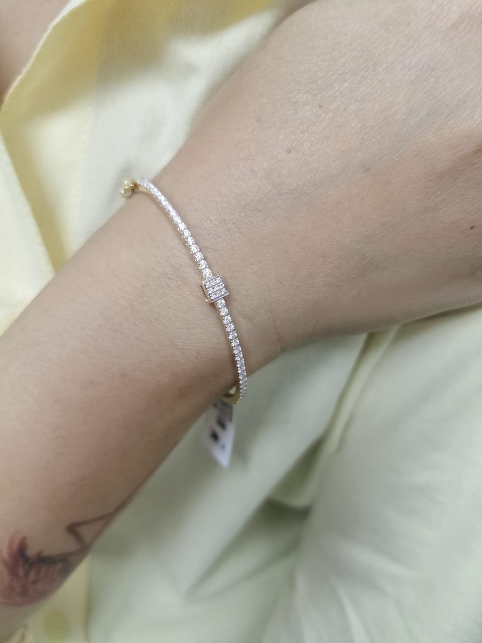 18K yellow gold diamond bangle bracelet with square diamond centerpiece and 0.92 carats of diamonds