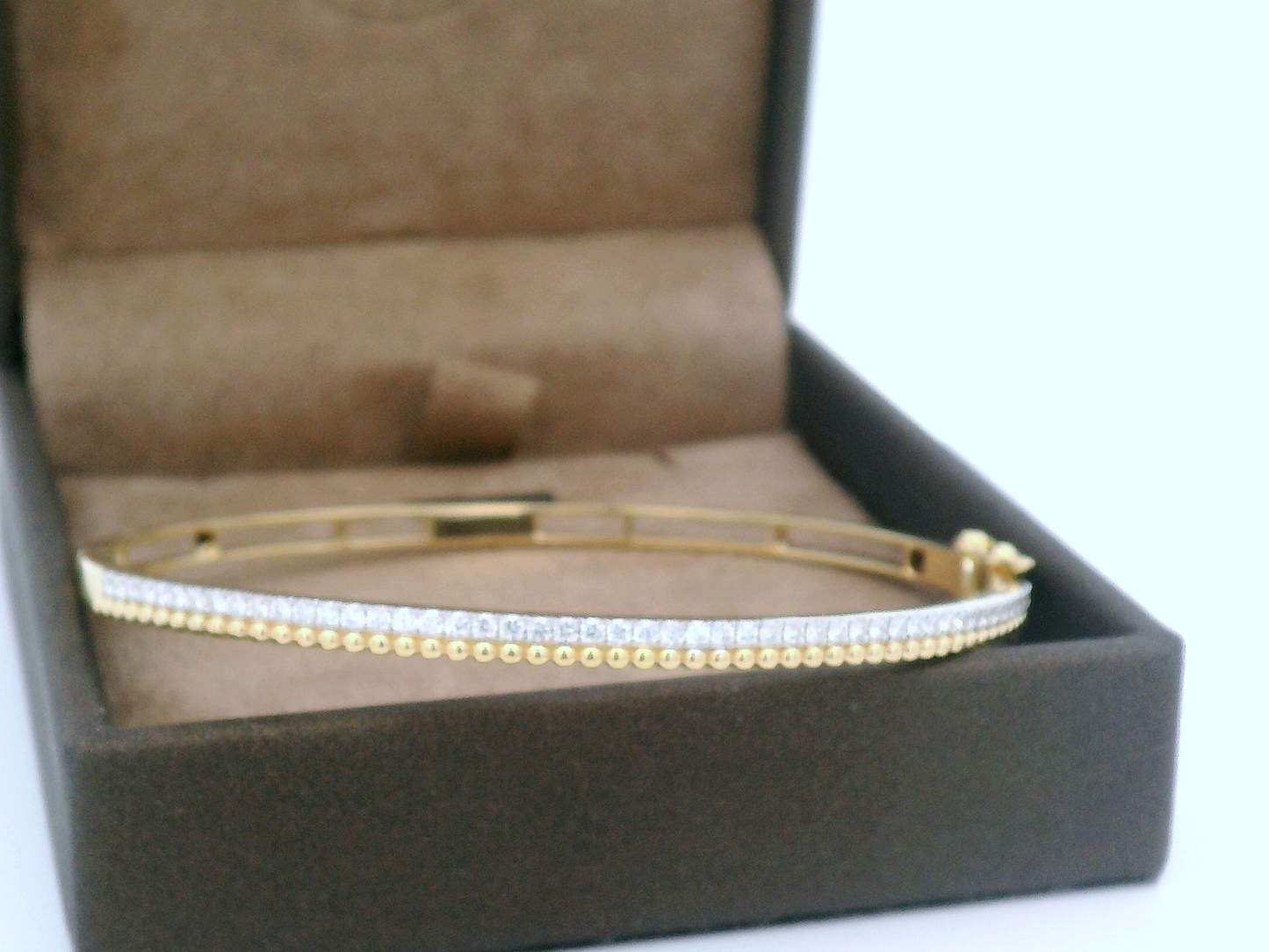 18K gold diamond bangle bracelet with beaded details and 0.57 carats of diamonds, featuring a sleek and elegant design.