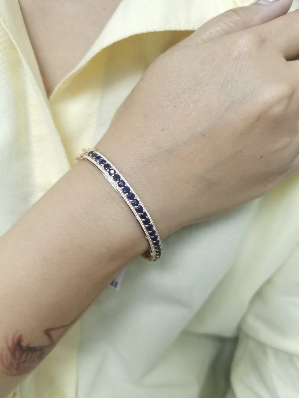18K rose gold bangle with blue sapphires and diamond accents, luxury gemstone bracelet