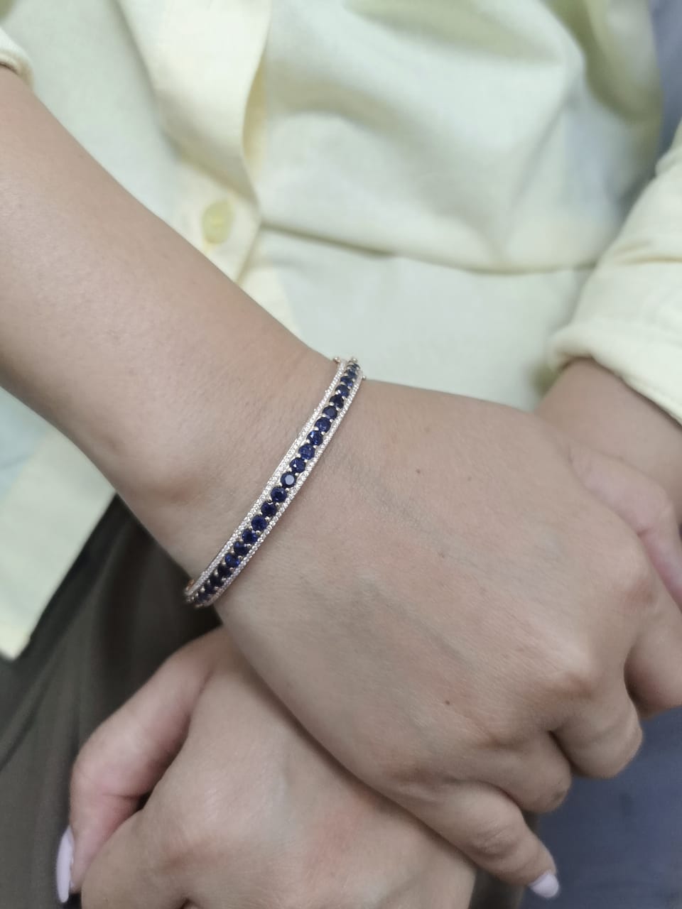 18K rose gold bangle with blue sapphires and diamond accents, luxury gemstone bracelet