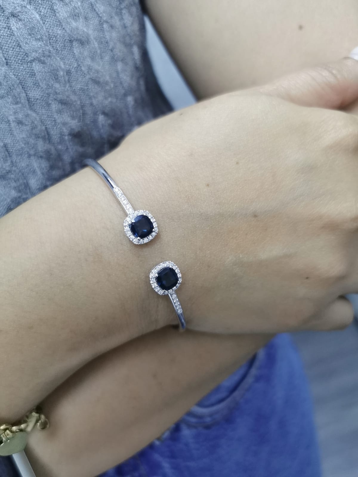 18K gold bangle with London Blue Topaz and diamond halo in an open cuff design.