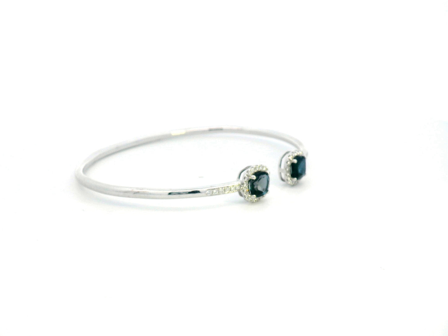 18K gold bangle with London Blue Topaz and diamond halo in an open cuff design.