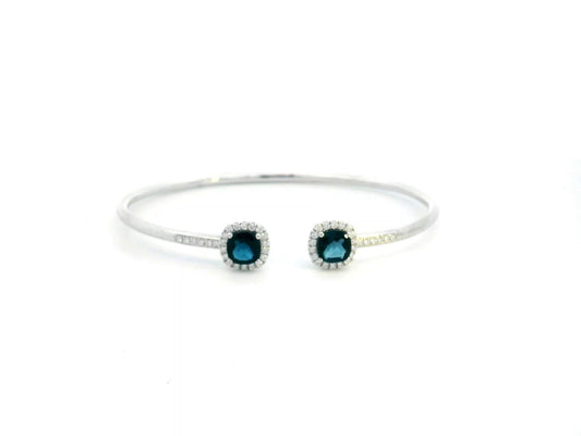 18K gold bangle with London Blue Topaz and diamond halo in an open cuff design.