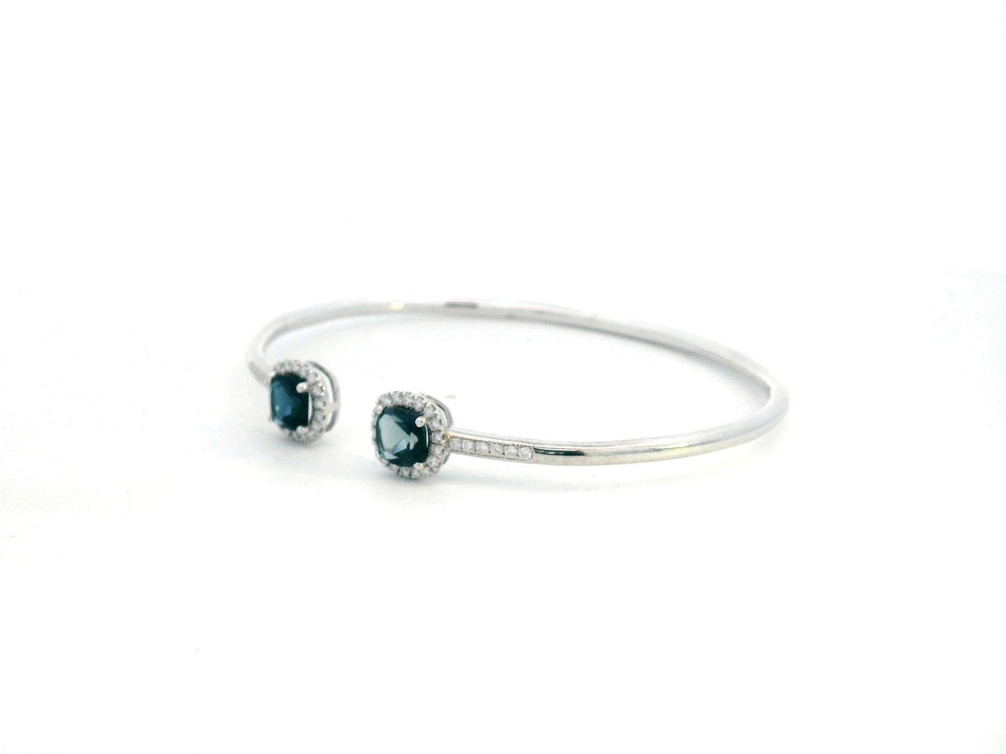 18K gold bangle with London Blue Topaz and diamond halo in an open cuff design.