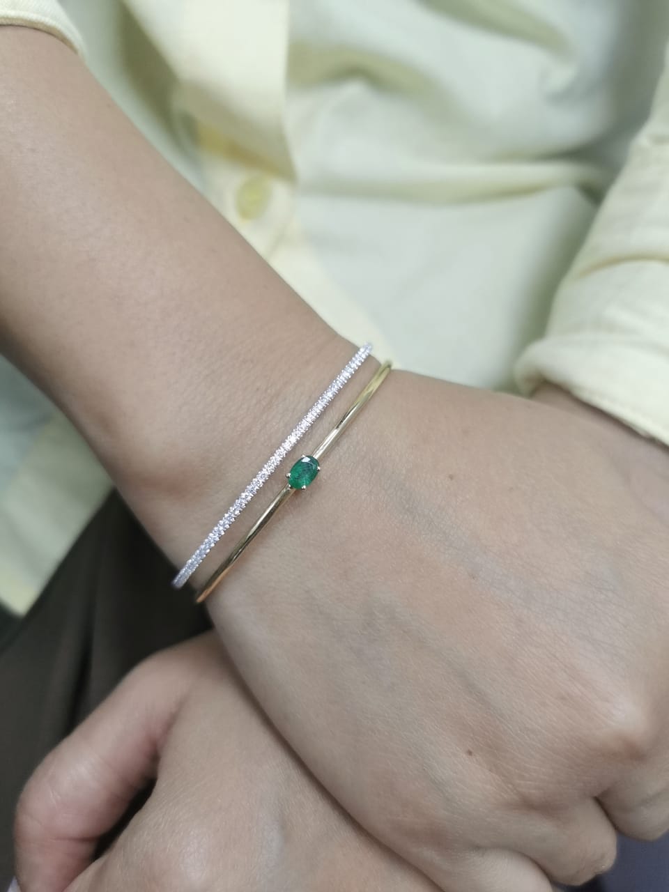 18K yellow gold open bangle with oval emerald and diamond band – 0.48ct emerald and 0.59ct diamond