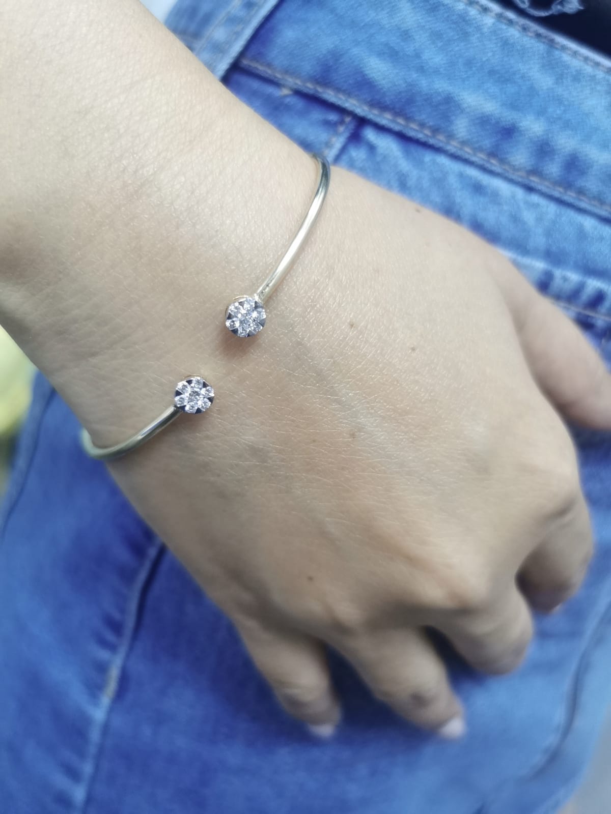 18K gold open bangle with round diamond cluster ends totaling 0.46 carats