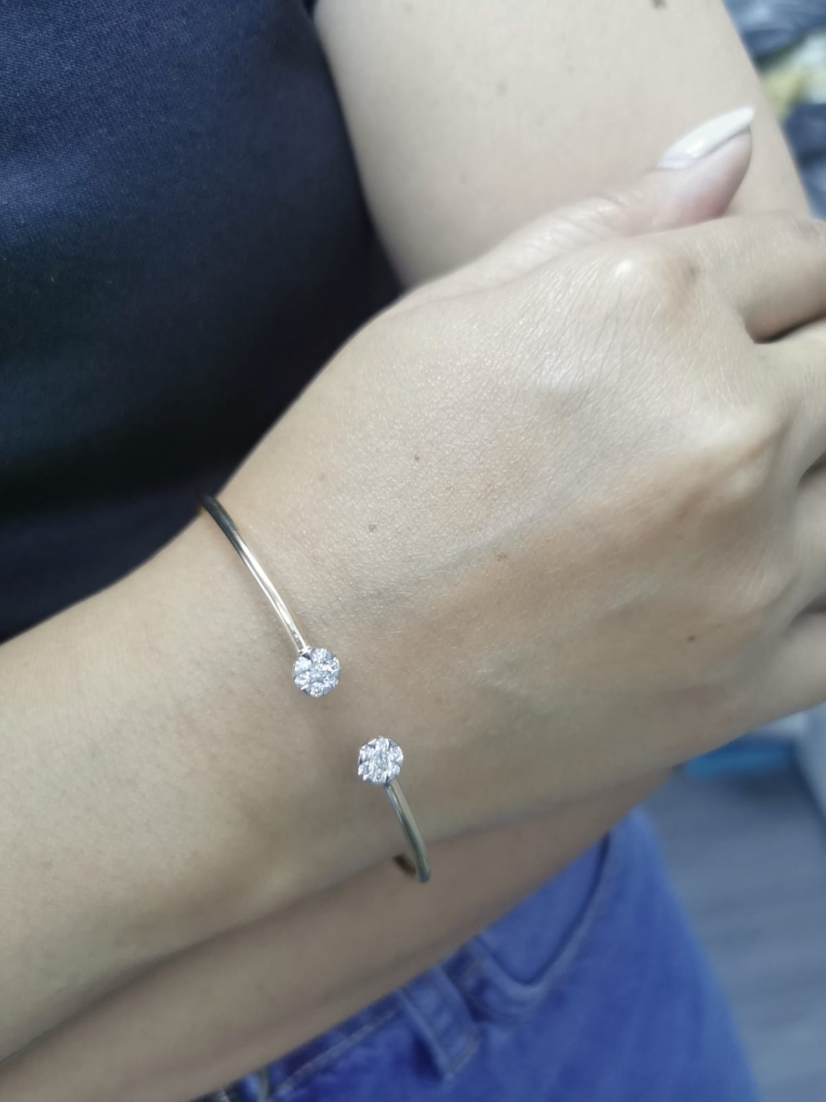 18K gold open bangle with round diamond cluster ends totaling 0.46 carats