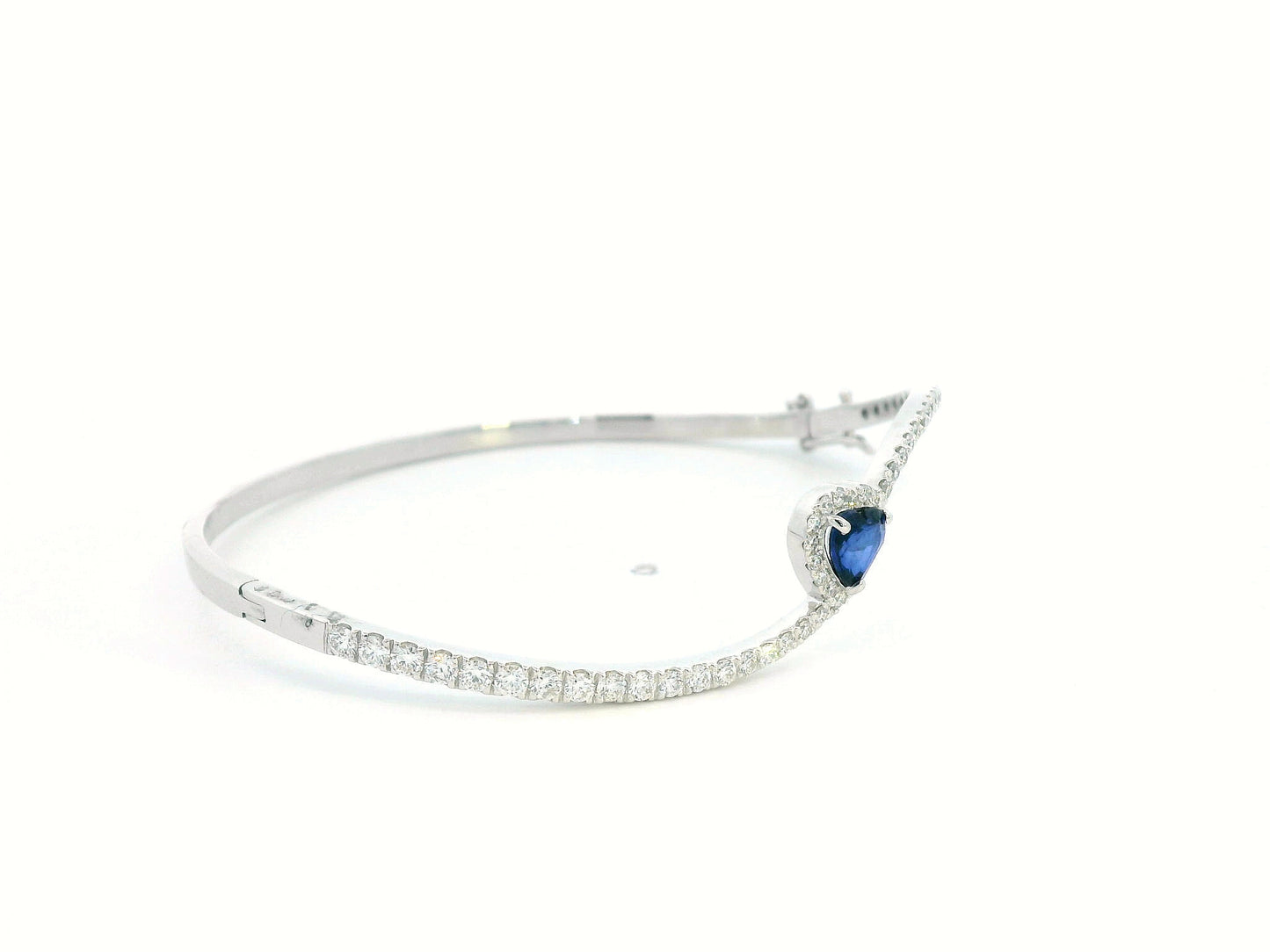 18K white gold bangle with heart-shaped 0.73ct blue sapphire and 1.2ct diamond halo and accents