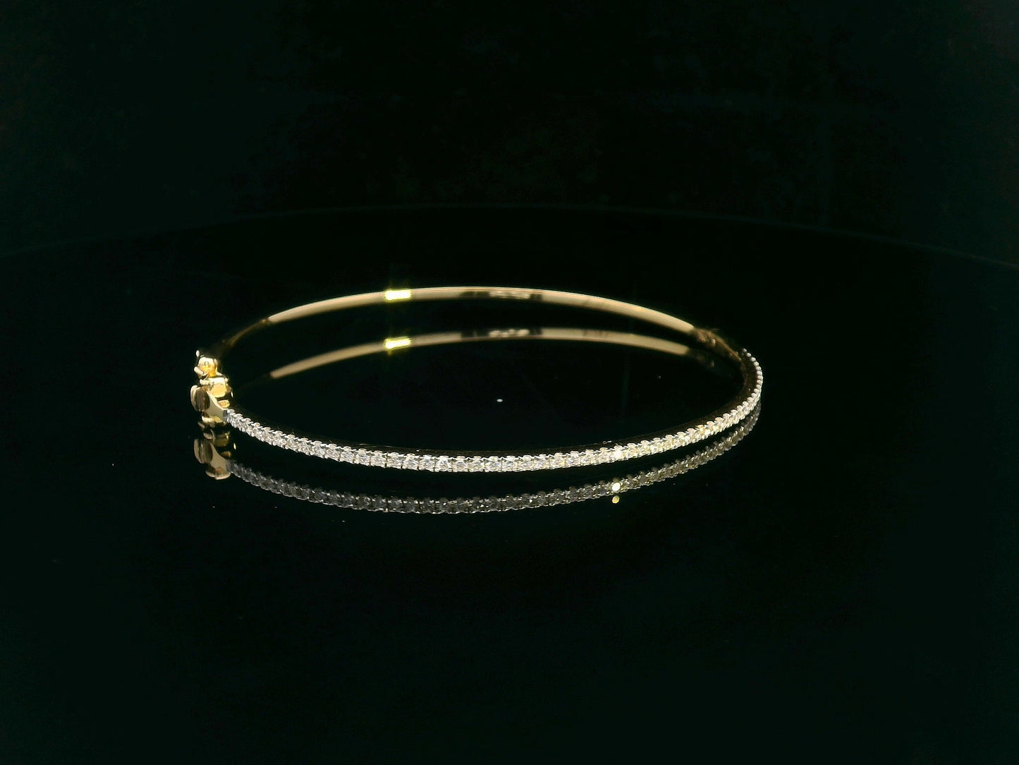 18K gold diamond bangle bracelet featuring 0.55 carats of round-cut diamonds, designed for timeless elegance and luxury.