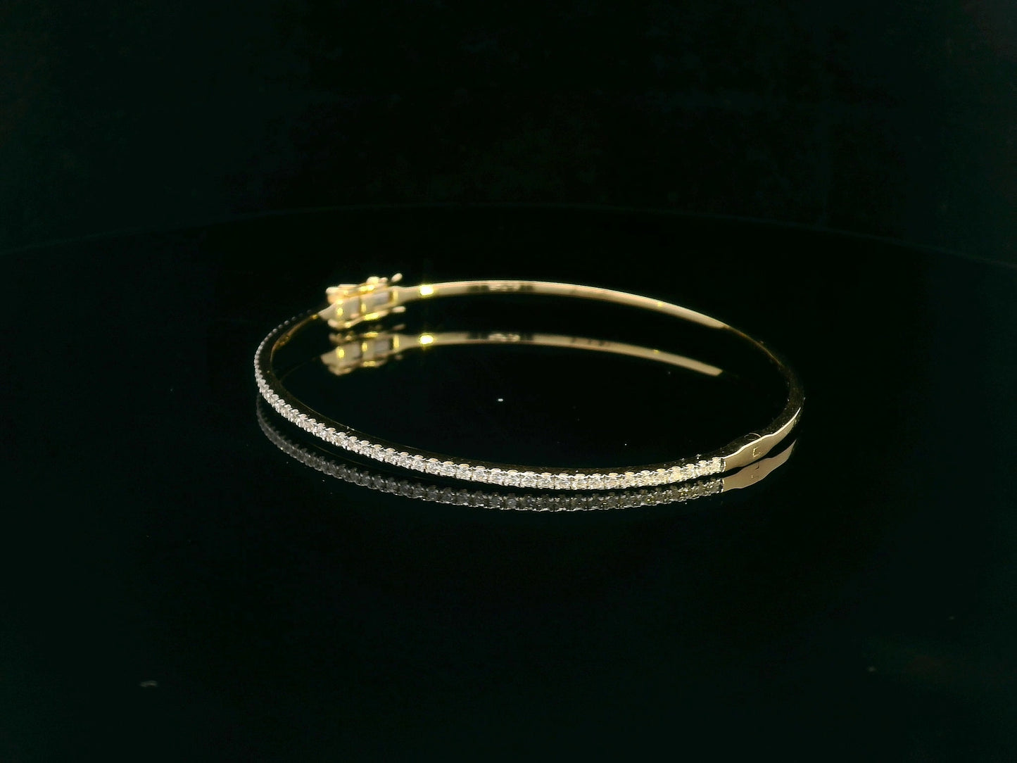 18K gold diamond bangle bracelet featuring 0.55 carats of round-cut diamonds, designed for timeless elegance and luxury.
