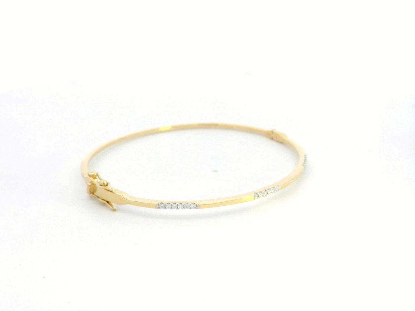 18K yellow gold minimalist bangle with 0.17 carat round-cut diamonds in triple accent design
