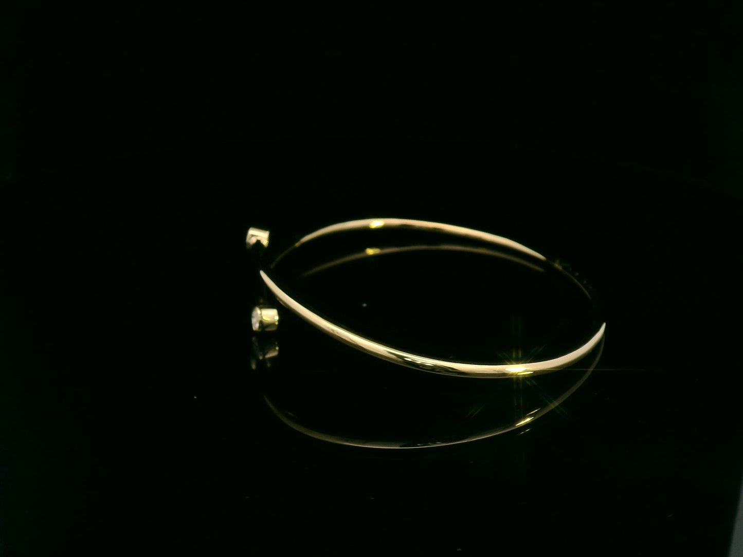 Diamond open cuff bangle bracelet in 18K yellow gold with bezel set diamonds by Emirates Diamonds