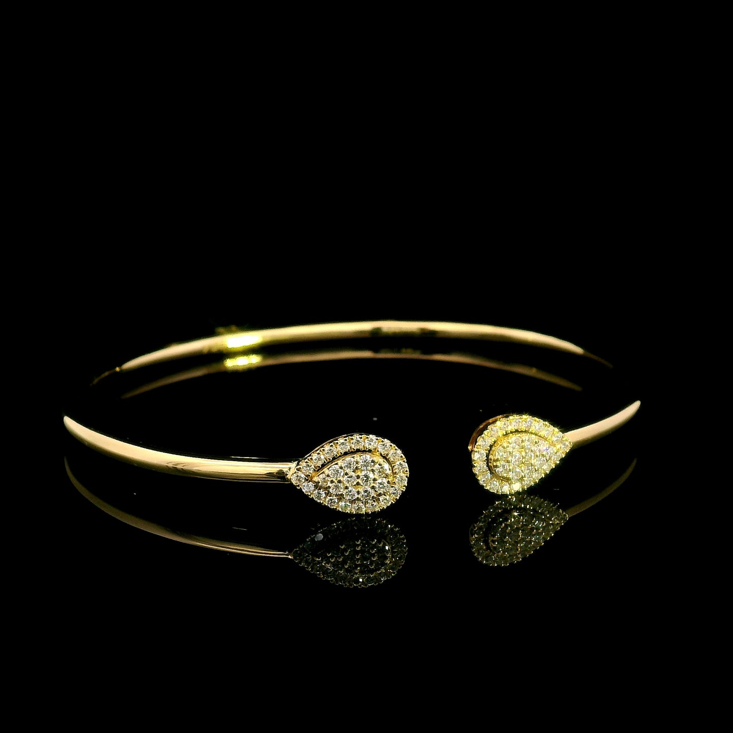 18K yellow gold open diamond bangle with twin pear-shaped diamond cluster ends.