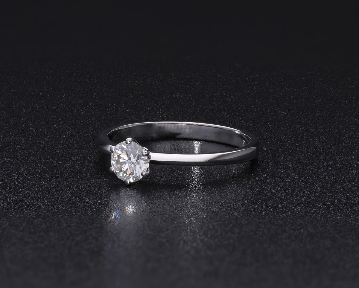 Round brilliant cut diamond solitaire engagement ring in 18K white gold featuring a 0.50 carat natural diamond in a six-prong setting on a slim polished band.