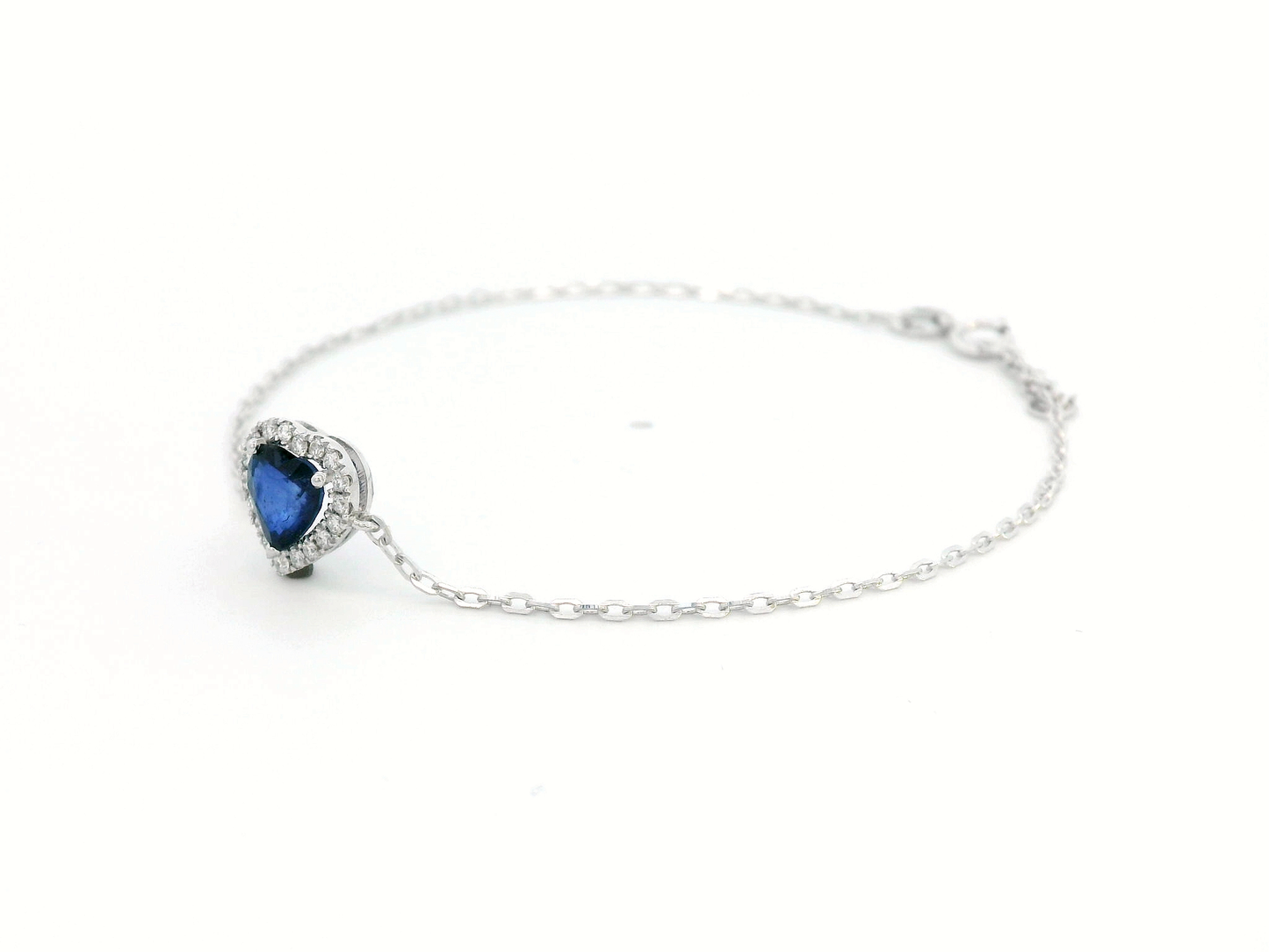 18K white gold heart bracelet featuring a 0.71 carat blue sapphire with diamond halo, total diamond weight 0.11 carat – Emirates Diamonds