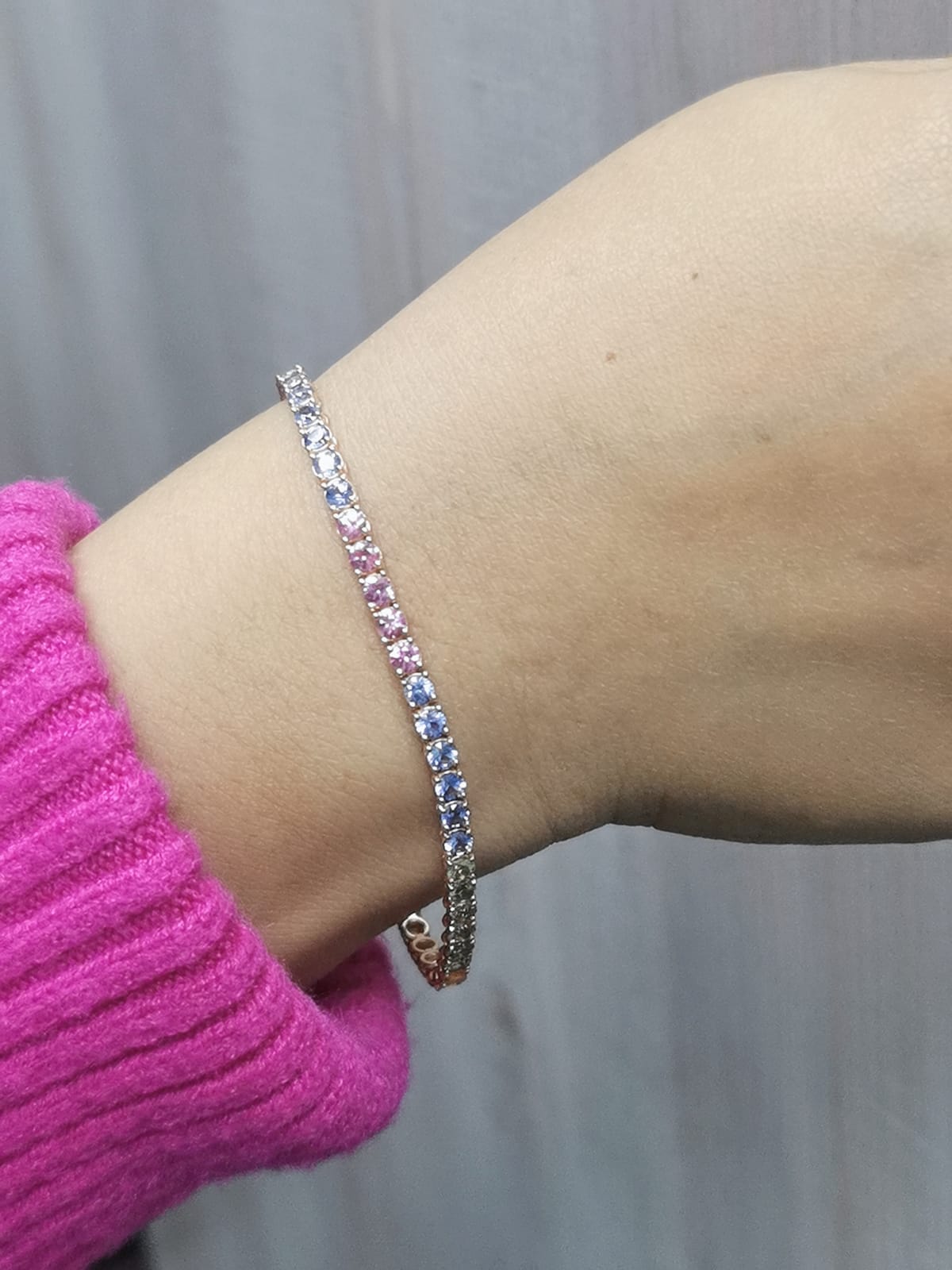 18K Rose Gold Multi-Sapphire Tennis Bracelet featuring 6.61 carats of vibrant round-cut sapphires in a classic design