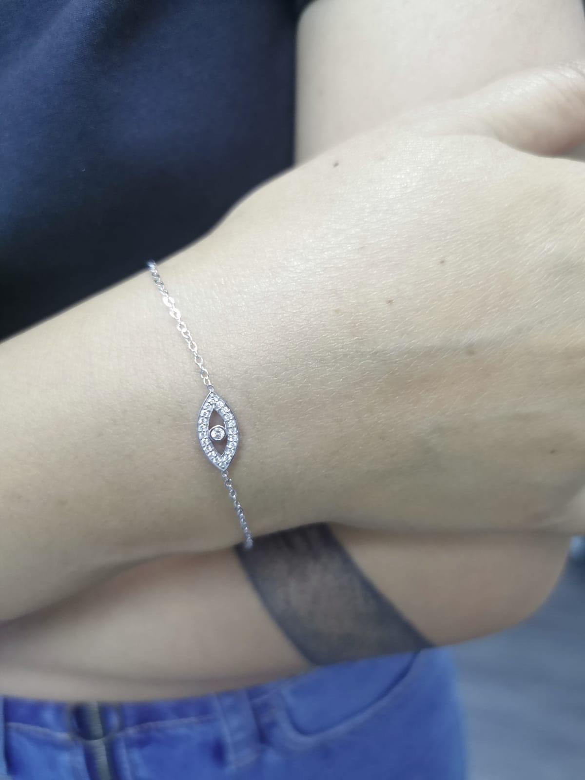 18K white gold evil eye bracelet with 0.14 carat diamonds on a delicate chain