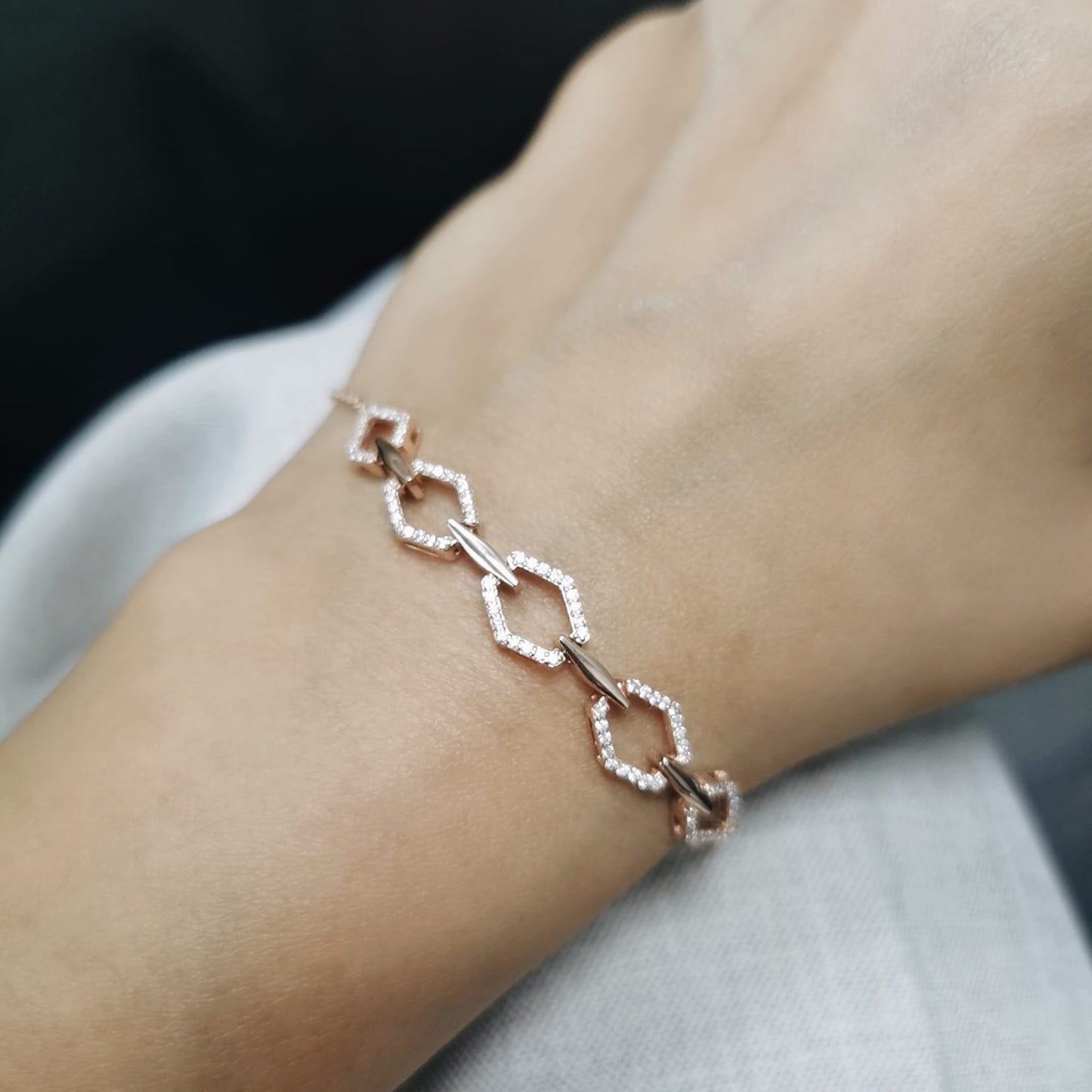 18K gold bracelet with five diamond-encrusted hexagon links and chain-link design